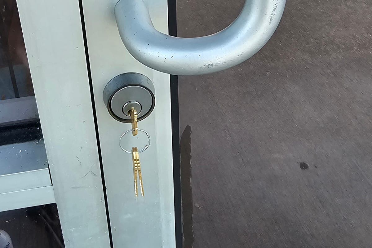 Keys in the lock cylinder of a glass storefront door